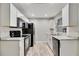 Modern kitchen featuring white cabinets, sleek black appliances, and light countertops at 2409 Wells Ave, Sarasota, FL 34232