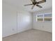 Bedroom featuring neutral carpet, a window with blinds, and a closet at 3140 Village Green Dr # 1119, Sarasota, FL 34239