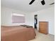 Comfortable bedroom with carpet floors, closet, light blocking shades, and wooden dresser at 3140 Village Green Dr # 1119, Sarasota, FL 34239