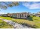 Delightful single-story home featuring multiple windows and a manicured lawn at 3140 Village Green Dr # 1119, Sarasota, FL 34239