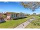Inviting home with multiple windows, vibrant landscaping, and a well-maintained lawn at 3140 Village Green Dr # 1119, Sarasota, FL 34239
