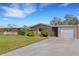 Charming single-story home with a well-manicured lawn and attached single-car garage at 3140 Village Green Dr # 1119, Sarasota, FL 34239