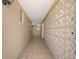 Hallway featuring neutral tile at 3140 Village Green Dr # 1119, Sarasota, FL 34239