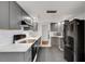 Modern gray kitchen features sleek cabinets, stainless steel appliances, and white subway tile backsplash at 3140 Village Green Dr # 1119, Sarasota, FL 34239