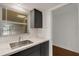 Bright kitchen features a modern sink, white subway tile backsplash, and sleek dark cabinetry at 3140 Village Green Dr # 1119, Sarasota, FL 34239