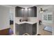 This compact kitchen features corner countertops, upper and lower cabinets, and modern appliances at 3140 Village Green Dr # 1119, Sarasota, FL 34239