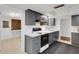 Modern kitchen featuring dark gray cabinetry, marble countertops, and stainless steel appliances at 3140 Village Green Dr # 1119, Sarasota, FL 34239