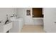 Laundry room with sink, washer, dryer, and storage with access to the exterior at 3140 Village Green Dr # 1119, Sarasota, FL 34239