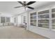Living room featuring neutral carpet, multiple windows, and bright light at 3140 Village Green Dr # 1119, Sarasota, FL 34239