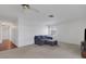 Spacious living area featuring plush carpeting, a comfortable sofa, and a ceiling fan at 3140 Village Green Dr # 1119, Sarasota, FL 34239