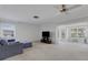 Bright living room featuring neutral carpet, a cozy couch, and lots of natural light at 3140 Village Green Dr # 1119, Sarasota, FL 34239