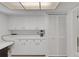 This kitchen pantry features white cabinets, ample counter space, and a mini-fridge at 3140 Village Green Dr # 1119, Sarasota, FL 34239