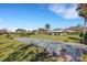 Active community shuffleboard court surrounded by manicured lawns and mature trees at 3140 Village Green Dr # 1119, Sarasota, FL 34239