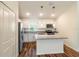Modern kitchen featuring white cabinets, granite countertops, stainless steel appliances, and a kitchen island at 3438 Alwood St, North Port, FL 34291