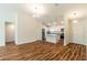 Open floor plan with wood flooring, a kitchen island and stainless appliances, and a welcoming entryway at 3438 Alwood St, North Port, FL 34291