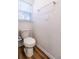 This bathroom features a standard white toilet and wood-look flooring at 3438 Alwood St, North Port, FL 34291