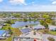 Scenic aerial view of community featuring a serene pond, well-maintained yards, and charming homes at 3611 22Nd W Ave, Bradenton, FL 34205