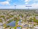 Overhead view of residential property by a pond, with the Gulf and Manatee River in the distance at 3611 22Nd W Ave, Bradenton, FL 34205