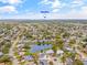 Serene aerial view of a home with pond frontage, close to beaches in a residential community at 3611 22Nd W Ave, Bradenton, FL 34205