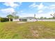 Spacious backyard featuring a white home with a screened patio and lush greenery at 3611 22Nd W Ave, Bradenton, FL 34205