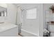 Clean, white bathroom with a shower-tub combo, updated vanity, and ample storage space at 3611 22Nd W Ave, Bradenton, FL 34205