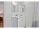 Bright bathroom featuring a modern white vanity with a stylish mirror and faucet, plus an adjacent shower with patterned curtain at 3611 22Nd W Ave, Bradenton, FL 34205