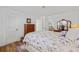 Bright bedroom featuring a plush, patterned comforter, wooden dresser, and a peek into the adjacent dining room at 3611 22Nd W Ave, Bradenton, FL 34205