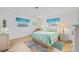 Bright bedroom with neutral walls, wood floors, and large windows with blue accents at 3611 22Nd W Ave, Bradenton, FL 34205