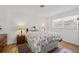 Cozy bedroom with a comfortable bed, floral comforter, wooden nightstands with lamps, and hardwood flooring at 3611 22Nd W Ave, Bradenton, FL 34205