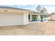 Exterior view of a home with a white facade, a garage, and a well-kept lawn with decorative plants at 3611 22Nd W Ave, Bradenton, FL 34205
