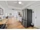 Bright kitchen featuring a stainless steel refrigerator, white cabinetry, wood-look floors, and an open layout into the living area at 3611 22Nd W Ave, Bradenton, FL 34205