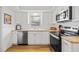 Kitchen with white cabinets, stainless steel dishwasher, and lots of countertop space at 3611 22Nd W Ave, Bradenton, FL 34205