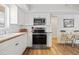 Bright kitchen features white cabinetry, modern appliances, and an adjacent dining area at 3611 22Nd W Ave, Bradenton, FL 34205