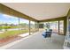 Enclosed lanai featuring a table and chairs with views of the pond and mature landscaping at 3611 22Nd W Ave, Bradenton, FL 34205