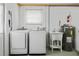 Functional laundry room with modern washer and dryer, utility sink, and a newer water heater at 3611 22Nd W Ave, Bradenton, FL 34205