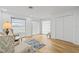 Open living room featuring wood floors, ample natural light, and cozy seating area at 3611 22Nd W Ave, Bradenton, FL 34205