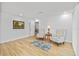 Bright living room with hardwood floors, two upholstered chairs, a small table with lamp and colorful wall art at 3611 22Nd W Ave, Bradenton, FL 34205