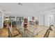 Open-concept living and dining area with hardwood floors and view to the outdoor area at 3611 22Nd W Ave, Bradenton, FL 34205