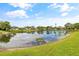Beautiful pond with clear reflections, surrounded by lush greenery and neighboring homes at 3611 22Nd W Ave, Bradenton, FL 34205