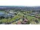 Aerial view of a golf course community, highlighting golf course, tennis courts and pool at 3704 Prairie Dunes Dr, Sarasota, FL 34238