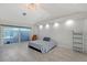 Bright main bedroom boasts tiled floors, recessed lights, a sliding glass door, and simple decor at 3704 Prairie Dunes Dr, Sarasota, FL 34238