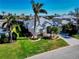 Aerial view of the residence features lush green grass, mature palm trees, and a well-maintained landscape design at 3707 5Th Ne Ave, Bradenton, FL 34208