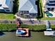 Aerial view featuring the rear of the home with a boat dock and a screened-in enclosure over the patio at 3707 5Th Ne Ave, Bradenton, FL 34208