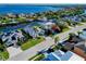 Aerial view of a waterfront community showcasing beautiful homes, lush landscaping, and various boats docked along the water at 3707 5Th Ne Ave, Bradenton, FL 34208
