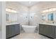 Luxurious bathroom featuring dual vanities, soaking tub, and elegant marble tile at 3707 5Th Ne Ave, Bradenton, FL 34208