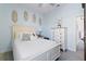 Bright bedroom showcasing a white bed, light blue walls, and natural decor at 3707 5Th Ne Ave, Bradenton, FL 34208