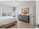 Serene bedroom with wood floors, a decorative dresser, and shuttered windows at 3707 5Th Ne Ave, Bradenton, FL 34208