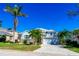 Charming home showcasing a well-manicured lawn, lovely palm trees, and a paved driveway on a clear, sunny day at 3707 5Th Ne Ave, Bradenton, FL 34208