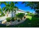 Beautiful home with meticulously landscaped yard, lush greenery, and mature palm trees on a bright, sunny day at 3707 5Th Ne Ave, Bradenton, FL 34208
