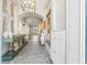 Inviting foyer with high ceilings, decorative mirror, stylish console table, and elegant chandelier at 3707 5Th Ne Ave, Bradenton, FL 34208
